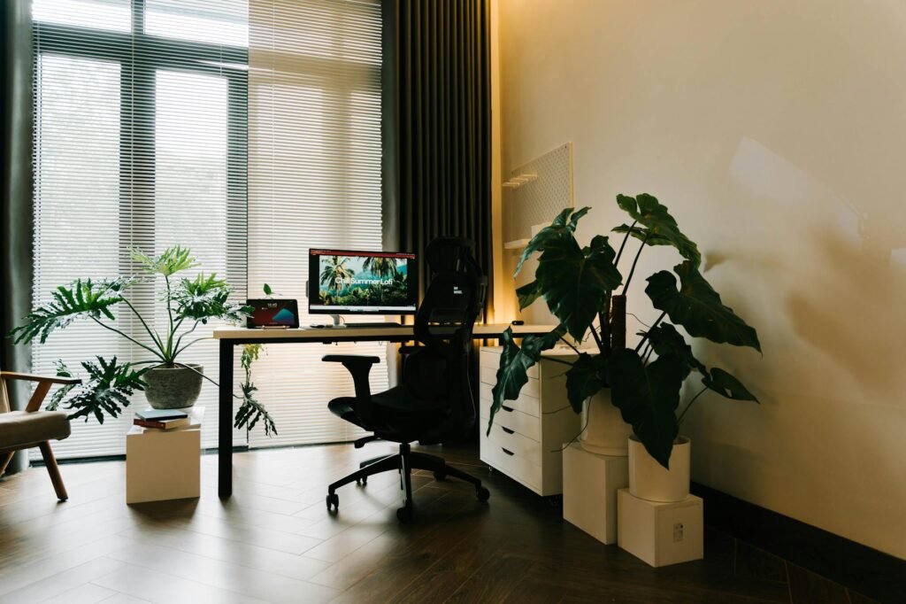 A large indoor floor plant with a wooden dowel used to check deep soil moisture